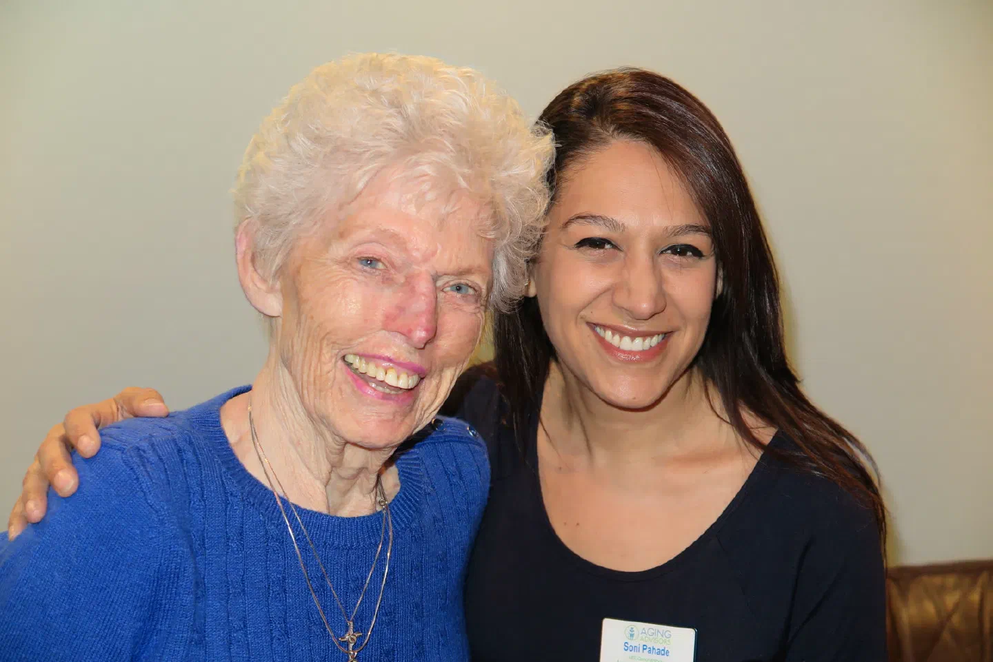 Soni Pahade of Aging Advisors smiling arm in arm with an older woman.
